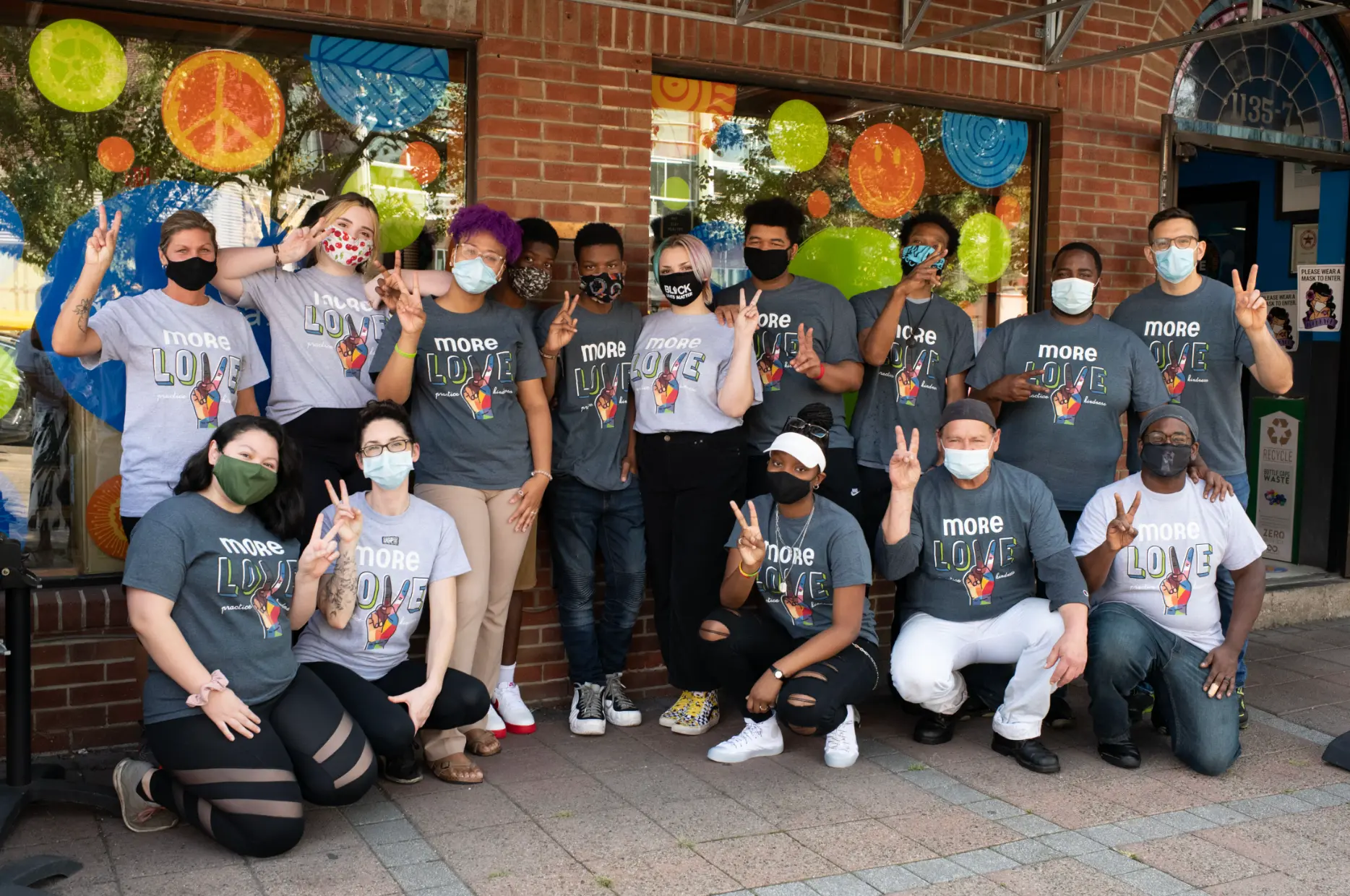 Amachi staff and youth gathered outside a community storefront