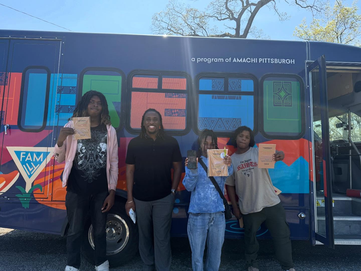 Amachi Ambassadors with certificates outside the HERE4U mobile unit