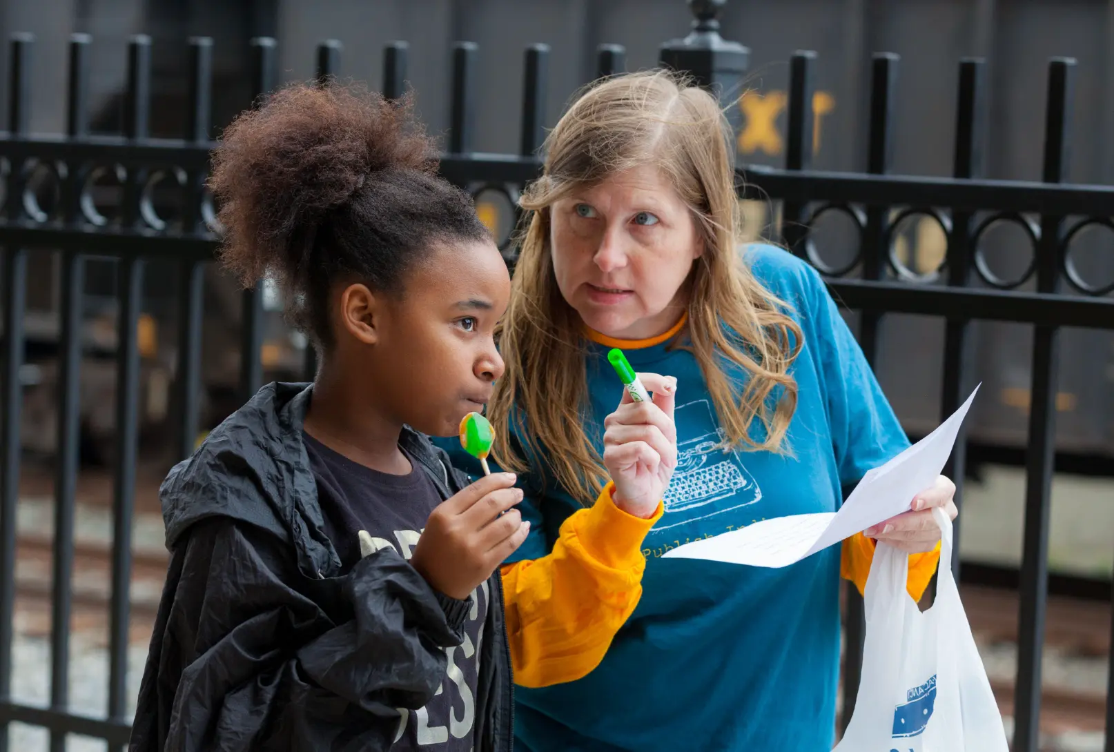 Staff member working one-on-one with a young girl outdoors