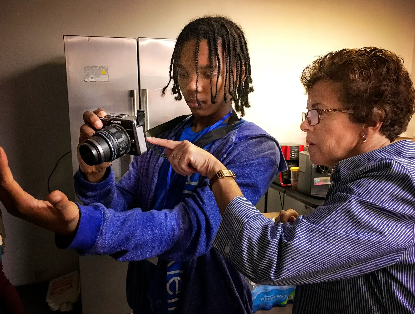 Mentor guiding a student through a camera lesson